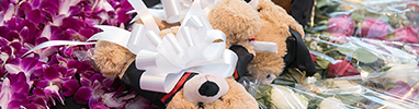 Flowers and teddy bears in graduation caps and gowns